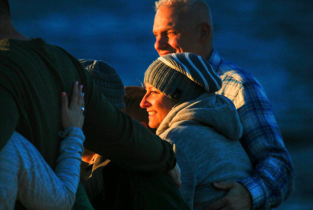 Heather Lopez and her fiance Jimmy Absher appear happy as they pose for photos with members of their family earlier this week on the beach at Mukilteo Lighthouse Park. (Dan Bates / The Herald)