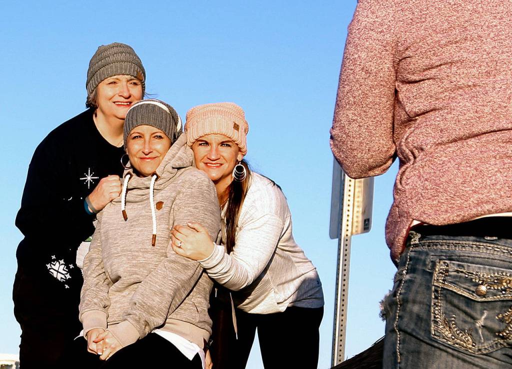 Marsha Lopez (left), Heathers mother, and Heathers sister, Jennifer Goodman, pose for photographer-friend Tessa Burrus Tuesday on the beach in Mukilteo. (Dan Bates / The Herald)