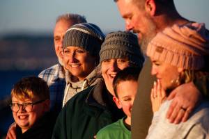 Heather Lopez (third from left), received bad news about new brain tumors, and was advised to do what she wants and what mattersnow. Lopez and her fiance, Jimmy Absher (second from left), have changed their wedding date from April to Dec. 17. Here, the couple and their family, Heathers son, Landon Tarpenian, 10, (left), her mom Marsha Lopez (middle), her sisters son, Gavin Goodman, 8, sisters husband Brooke Goodman and her sister Jennifer Goodman gather on Mukilteo beach so photographer-friend Tessa Burrus can take family pictures. (Dan Bates / The Herald)