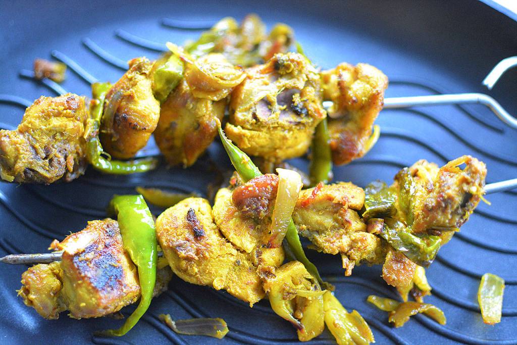 Turmeric chili chicken skewers can be marinated the day before and grilled in your stovetop pan minutes before guests arrive. (Reshma Seetharam)
