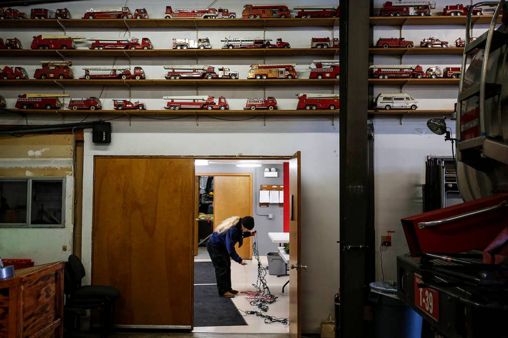 Handmade fire engine models line the wall of the Darrington Fire Department on Tuesday, Dec. 12. The department is made up of one full-time captain and 24 volunteers. (Ian Terry / The Herald)