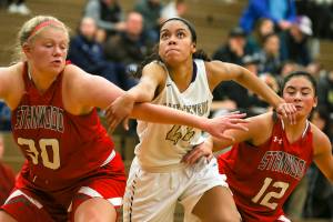 Stanwoods Kaitlin Larson, L-R, Lake Stevens Kylee Griffen and Lake Stevens Savannah Smith look for a rebound off a free throw Wednesday night at Lake Stevens High in Lake Stevens on December 6, 2017. The Vikings won 56-45. (Kevin Clark / The Herald)