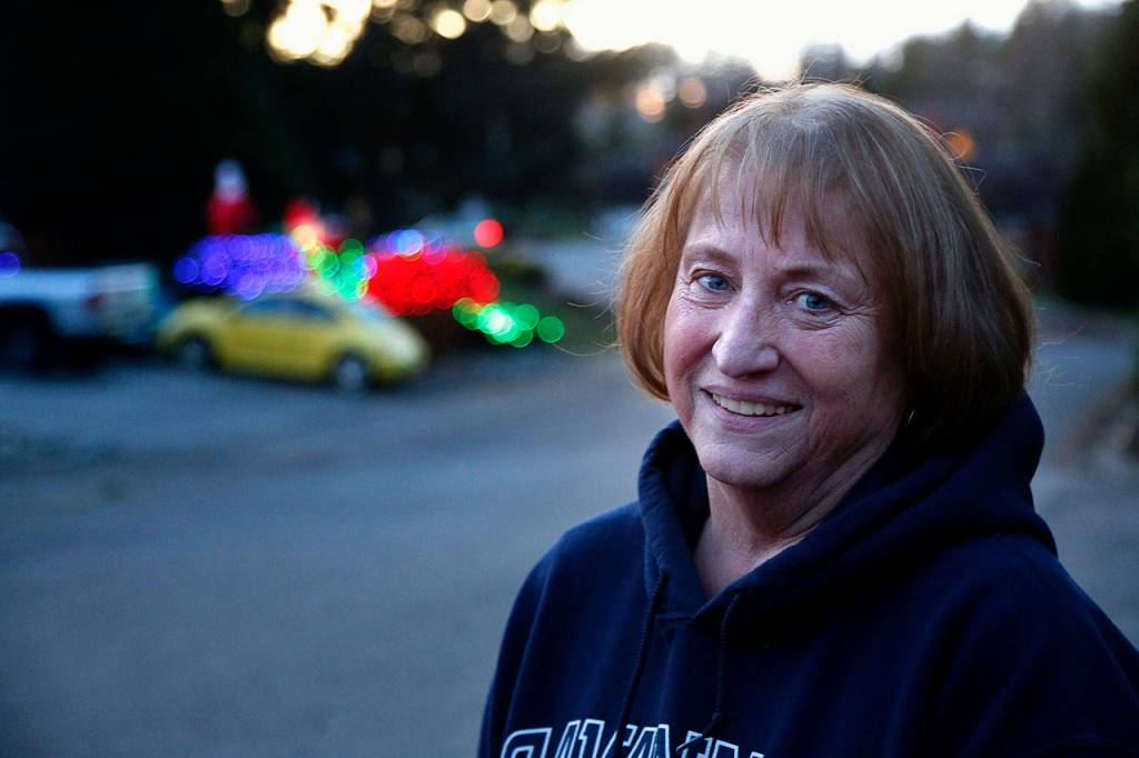 Jackie Noble has lived in Everetts Fir Grove neighborhood since 1976. Her brightly lit house is across the street from the neighborhood park where Santa collects food and cash donations for Volunteers of America till Christmas. (Dan Bates / The Herald)