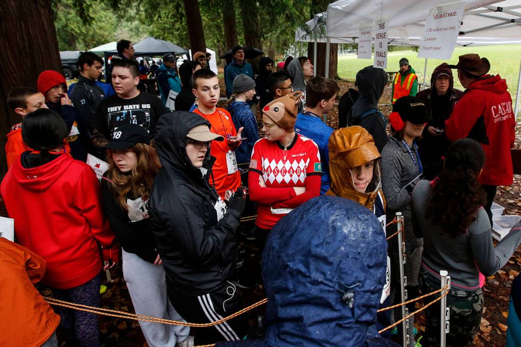 Competitors await the start of an orienteering race organized by the Washington Interscholastic Orienteering League on Dec. 2 at Saint Edward State Park in Kenmore. (Ian Terry / The Herald)