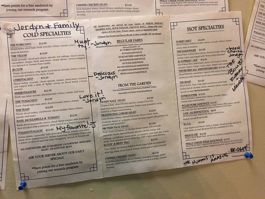 The wall near the front door is adorned with menus marked with happy customers reviews of the items. (Ben Watanabe / The Herald)