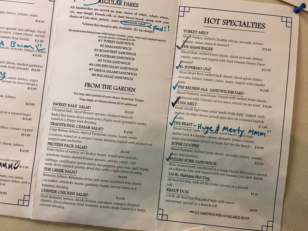 The wall near the front door is adorned with menus marked with happy customers reviews of the items. (Ben Watanabe / The Herald)