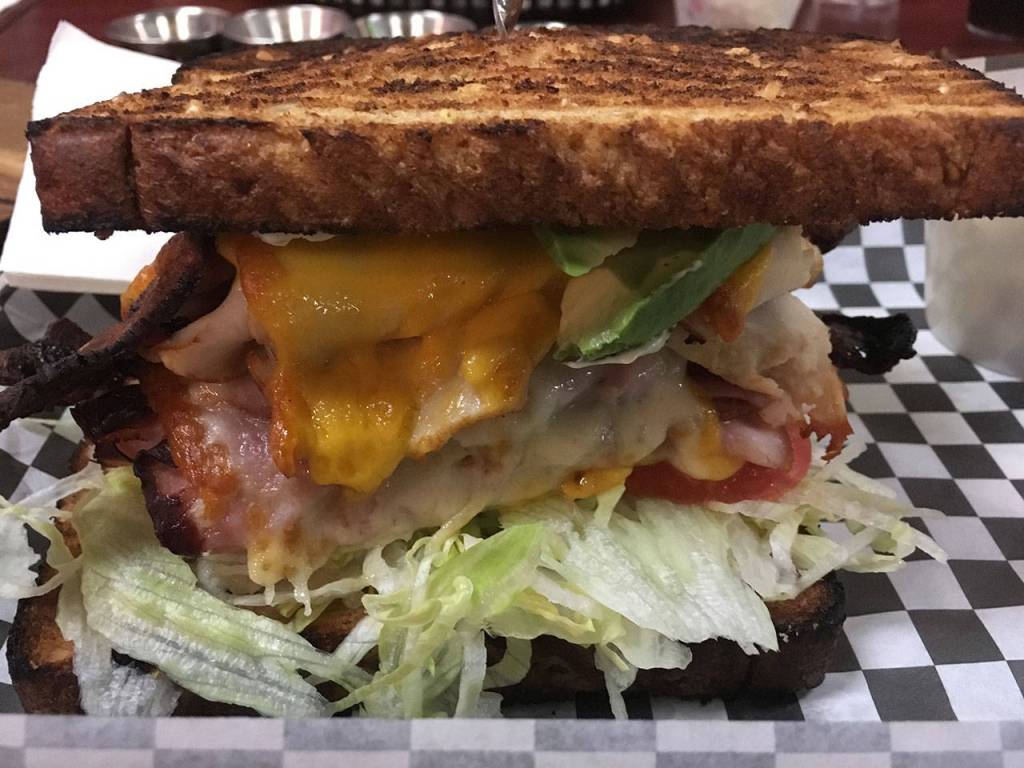 The Beast at Christas Sandwichboard lives up to its intimidating name. Stacked with turkey, ham and bacon, youll need to be hungry to down it one sitting. (Ben Watanabe / The Herald)