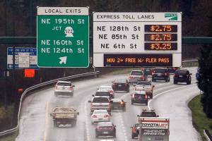 Signs show the rates for using the express toll lanes for traffic headed southbound on Interstate 405, Tuesday, Feb. 16, 2016, in Bothell, Wash. Gov. Jay Inslee announced plans Tuesday to try to decrease congestion on I-405 in answer to commuter complaints that the new express lane tolling system is making traffic worse. The governor said he would not be shutting down the tolling system as some people have called for. But the state transportation department is making plans to add new northbound general purpose lanes to ease some of the congestion and also plan to make it easier to move into and out of the express lanes. (AP Photo/Elaine Thompson)
