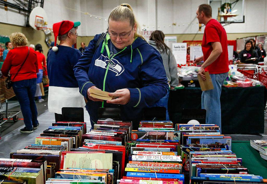 Rane Robinson, of Mountlake Terrace, shops for two teenage girls Friday at Christmas House. Its pretty hard day today  without this, there probably would be no Christmas. (Dan Bates / The Herald)
