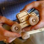 Leroy McVay, 85, of Everett, makes wooden toys to be donated to children. He uses a wood-burning pen for detail work on a variety of trucks, trains, tractors and more. (Dan Bates / The Herald)