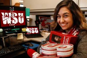 Sarah Reyes, a city of Everett communications officer, is an avid Cougar fan. Her 10th-floor city office space is pretty much tricked out in Cougar colors. (Dan Bates / The Herald)
