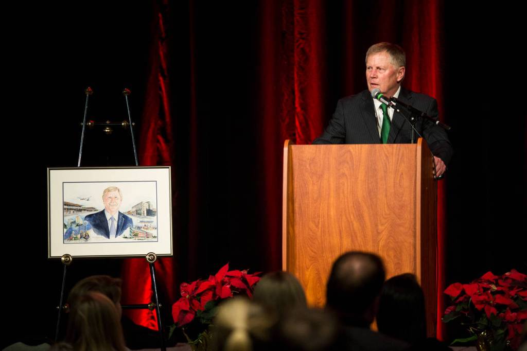 With his official portrait by him, Mayor Ray Stephanson speaks to an audience as his farewell celebration in the Ed Hansen Conference Center at Xfinity Arena on Dec. 12 in Everett. (Andy Bronson / Herald file)