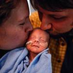 Elisabeth Strom and husband Steve Strom of Marysville kiss their son, Hugo, who was born on the way to the hospital Dec. 2, at 30 weeks. He weighed 3 pounds, 11.6 ounces. Hugo is in neonatal intensive care for several more weeks. (Dan Bates / The Herald)