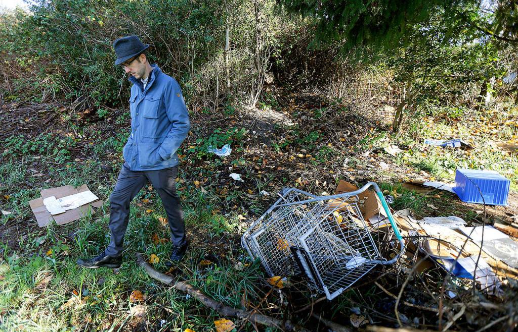 Hil Kaman walks near what once was a homeless encampment adjacent to the site of a planned low-barrier housing project on city land that will eventually house 65 chronically homeless people. Kaman is a former prosecutor who became the citys public health and safety director in 2016. (AP Photo/Ted S. Warren)