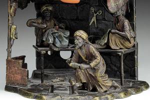 Cold-painted bronze lamp features a cobbler shop scene