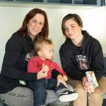 Brandii Cantrell (right) sits with her son Braden and friend Vicki Sage at the Housing Hope grand opening of Twin Lakes Landing. (William Wright/Housing Hope)