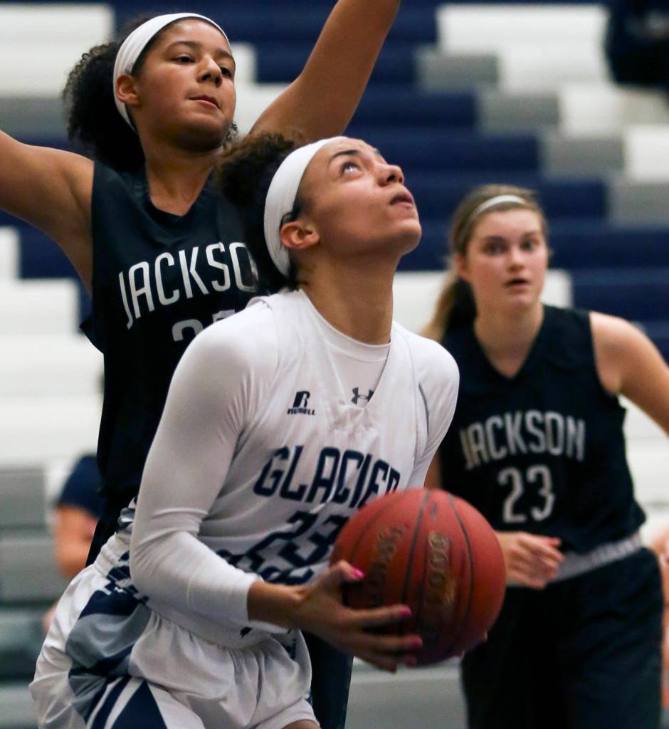 Glacier Peaks Alexyss Newman looks for a shot with Jacksons Olivia Skibiel defending at Glacier Peak High School in Snohomish on Dec. 15. Glacier Peak won 63-46. (Kevin Clark / The Daily Herald)