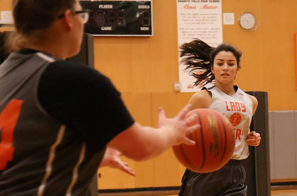 Granite Falls Sadie Hutchinson (left) receives a pass from Jenny Rodenbaugh during practice on Dec. 19, 2017, at Granite Falls High School. (Kevin Clark / The Herald)