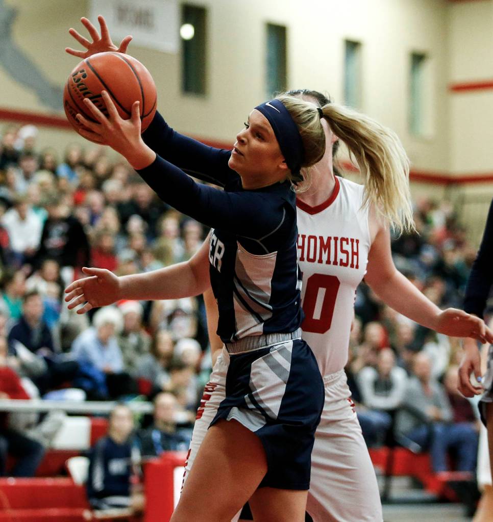 Glacier Peaks Haley Grambo grabs a rebound during a game against Snohomish on Dec. 19, 2017, at Snohomish High School. (Ian Terry / The Herald)