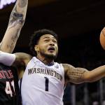 Washingtons David Crisp (1) drives past Seattles Aaron Menzies during a game Nov. 24, 2017, in Seattle. (AP Photo/Elaine Thompson)