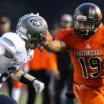 Monroes Isaiah Lewis (right) stiff-arms Glacier Peaks Evan Christie during a game on Sept. 29, 2017, at Monroe High School. (Kevin Clark / The Herald)