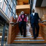 Dr. Larry Schecter (left), associate dean for WSU North Puget Sounds medical education programs, walks down the central staircase with Chancellor Paul Pitre at Washington State University Everett. The campus, which opened in 2017, will attract youth and talent to Everett and Snohomish County. (Ian Terry / The Herald)
