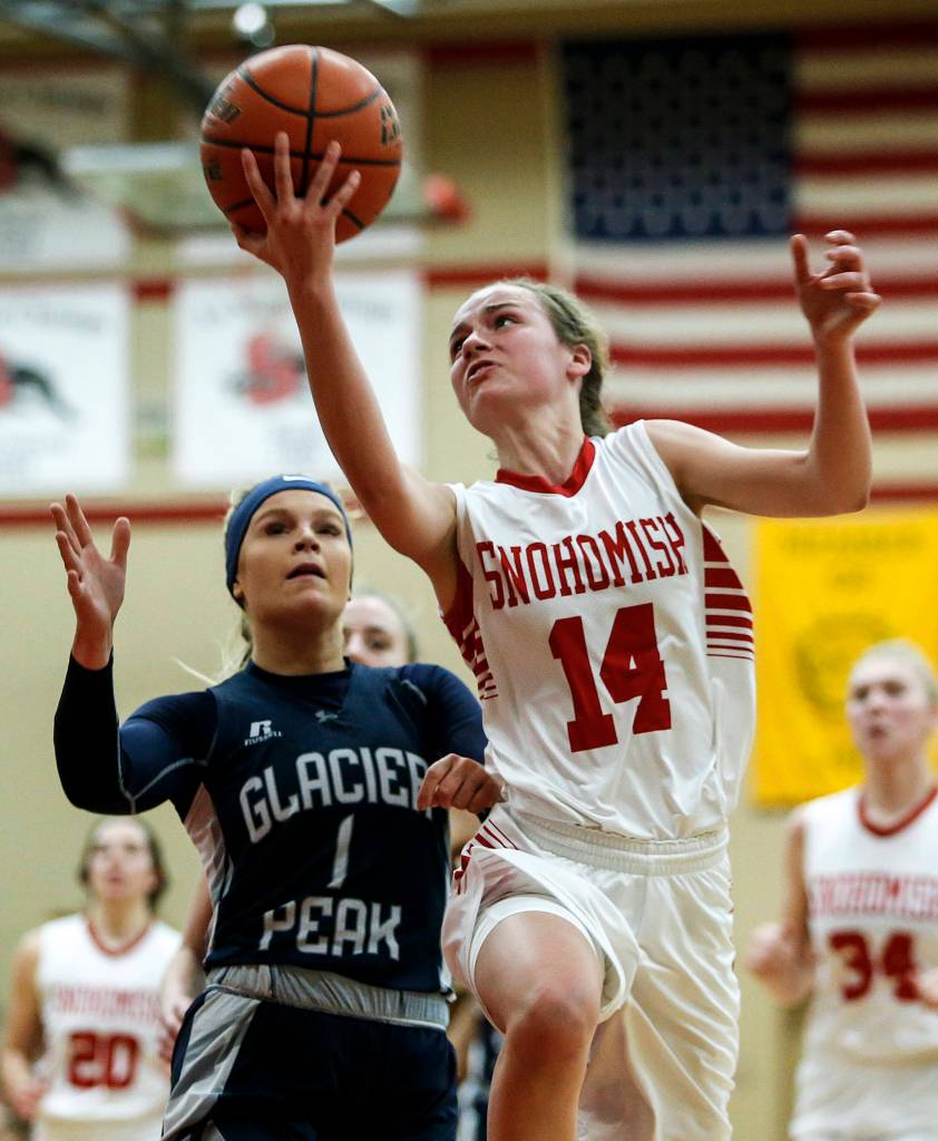 Snohomishs Maya DuChesne (14) goes up for a shot as Glacier Peaks Haley Grambo (1) defends during a game at Snohomish High School on Dec. 19. (Ian Terry / The Herald)