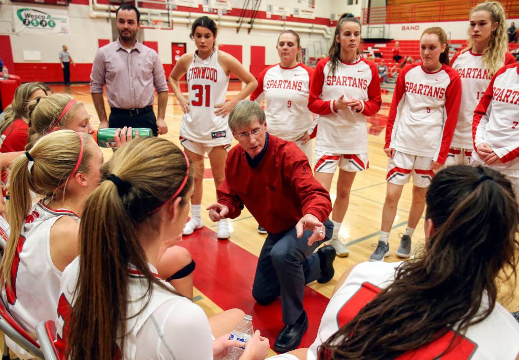 Dennis Kloke, Stanwood varsity head coach, addresses his team during a timeout against Everett High at Stanwood High School on Dec. 13. (Kevin Clark / The Daily Herald)