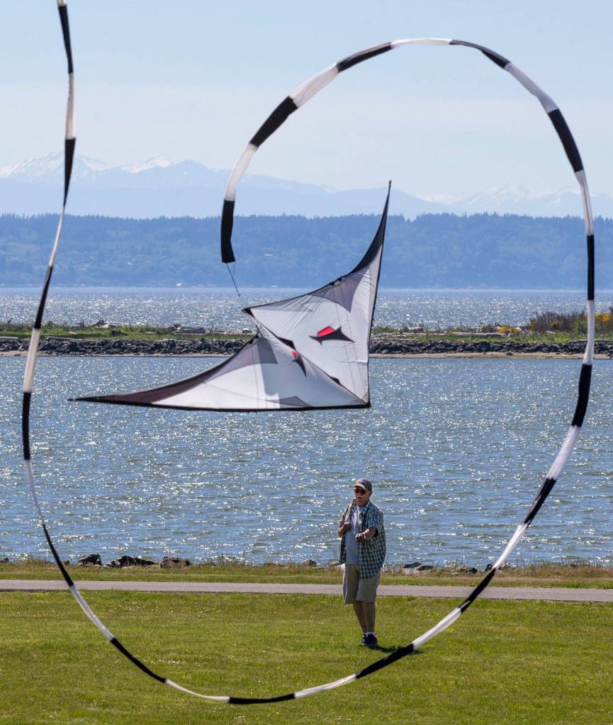Jim Dygert, of Lynnwood, turns loops with his dual-line stunt kite at Boxcar Park on May 22 in Everett. (Andy Bronson / The Herald)