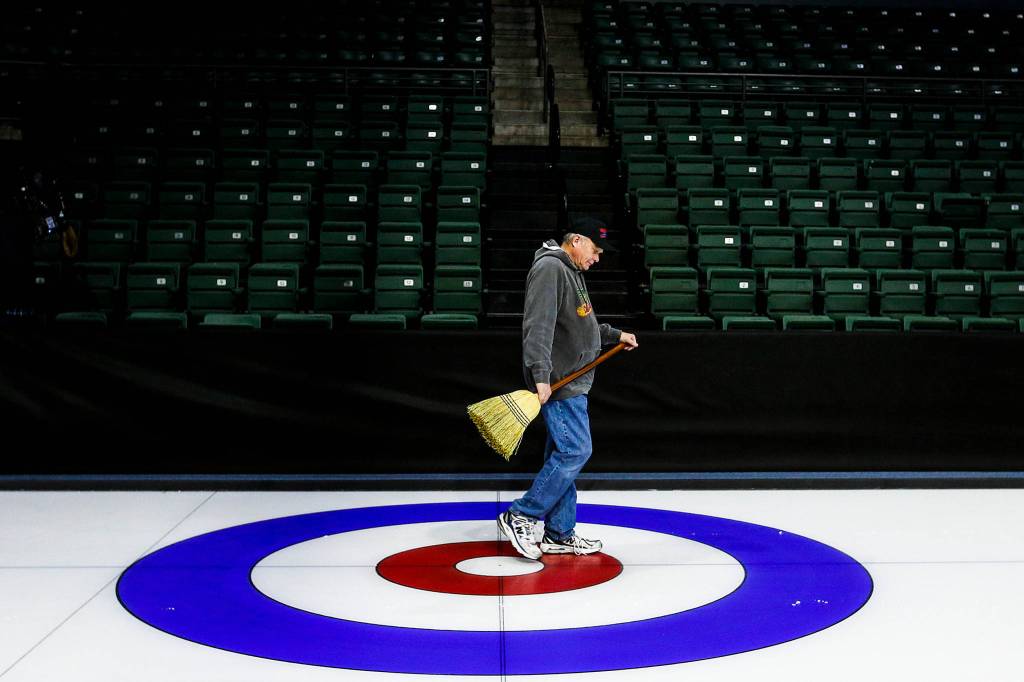 Dave Staveteig, head ice technician for USA Curling, walks along a sheet of ice during preparation on Feb. 10 for the 2017 USA Curling National Championships at Xfinity Arena. (Ian Terry / The Herald)