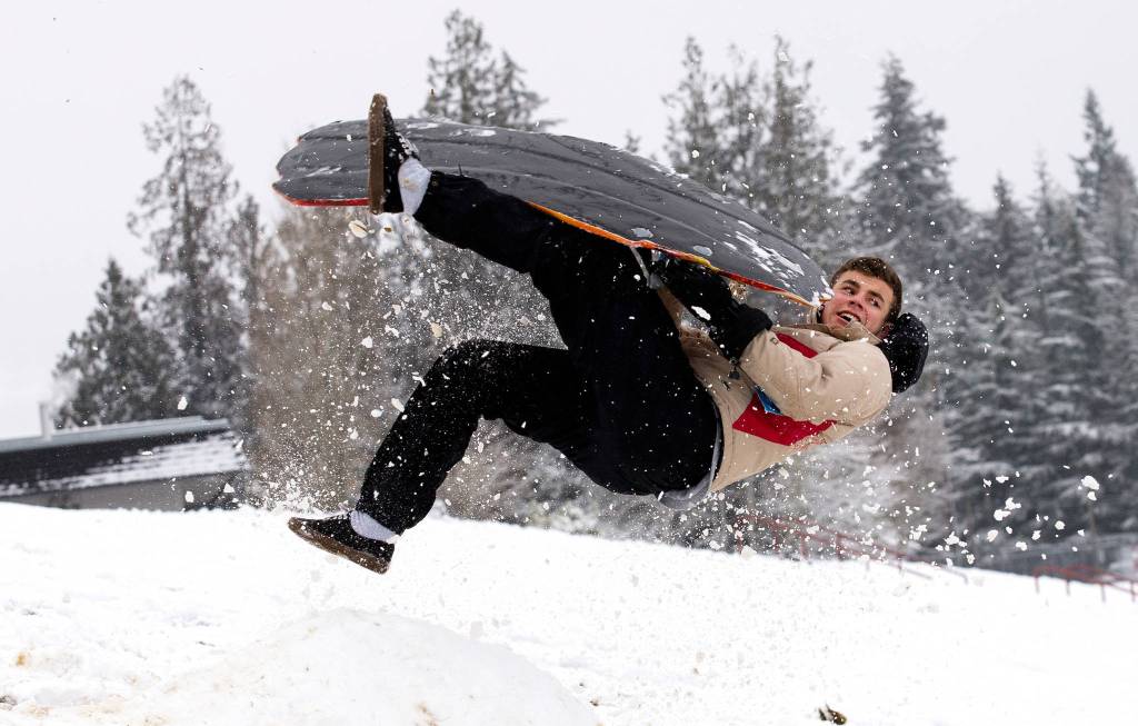Jalen Velasquez, a junior at Stanwood High, is thrown upside down after hitting a jump at the school on Feb. 6 in Stanwood. (Andy Bronson / The Herald)