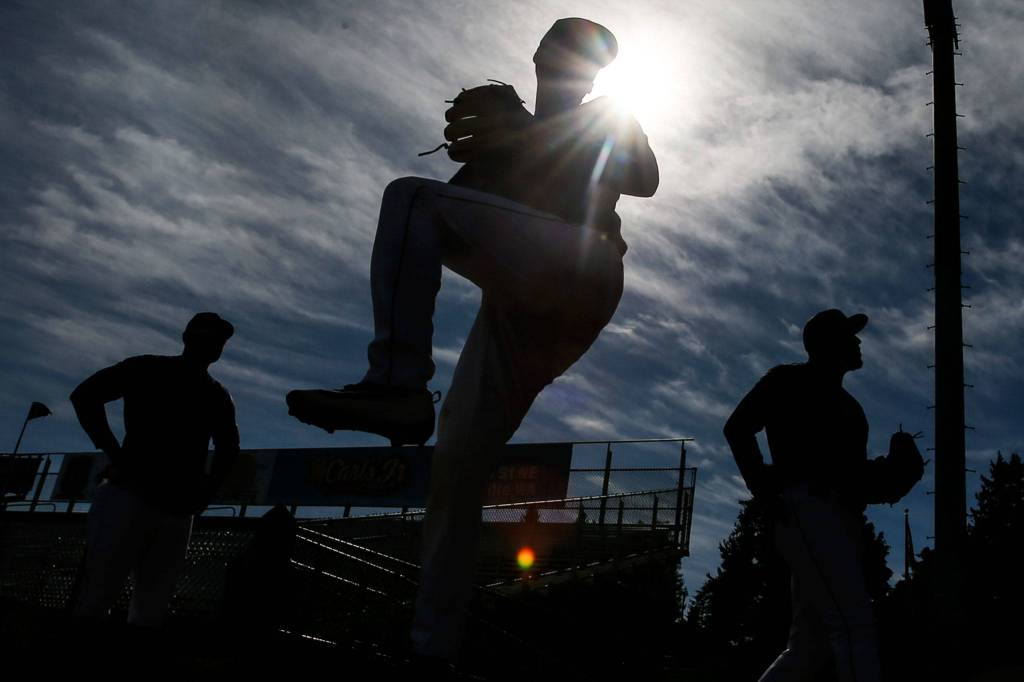 Members of the pitching core warm up during the first day of Aquasox training at Everett Memorial Stadium in Everett on June 11. (Kevin Clark / The Herald)