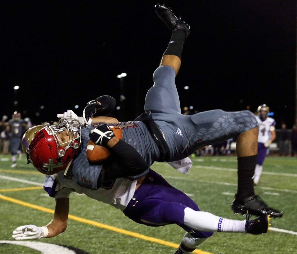 Archbishop Murphys Kyler Gordon makes a reception as North Kitsaps Josh Steakhouse defends at Veterans Memorial Stadium in Snohomish on Nov. 17. (Kevin Clark / The Herald)