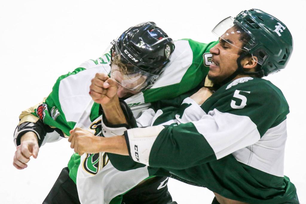 Prince Alberts Zack Hayes (left) and Everetts Montana Onyebuchi trade blows at Xfinity Arena in Everett on Nov. 15. Everett won 2-0. (Kevin Clark / The Herald)