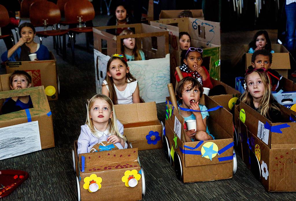 Snohomish-area children enjoy watching movies April 3 at the Snohomish Librarys My First Drive-in event. The youngsters, age 3 and older, brought cardboard boxes from home and transformed them into cars. (Dan Bates / The Herald)