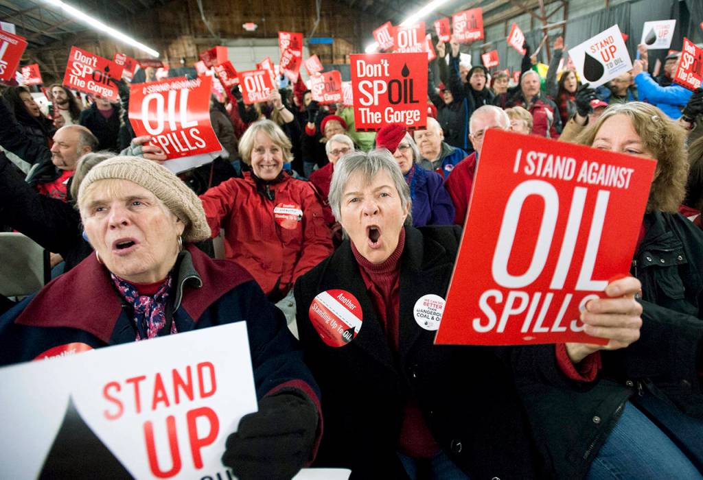 In this Jan. 5, 2016 photo, Maureen Hildreth (center) shouts as she protests with others during a public hearing on a proposed southwest Washington state massive oil-handling facility in Ridgefield, Washington. (Natalie Behring/The Columbian via AP, File)