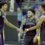 Washingtons David Crisp (center) Matisse Thybulle (left) and Hameir Wright celebrate during the Huskies win over Kansas on Dec. 6 in Kansas City, Mo. UW begins Pac-12 play Friday against USC. (AP Photo/Charlie Riedel)