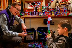 Nick Spicher, a new program innovation manager at Everetts Imagine Childrens Museum, talks with Ezra Tamas, 5, Wednesday, while the youngster builds things with educational toys called brackitz. Ezra, who will turn 6 in a few days, goes to the museum nearly every week with his mom, Estera Tamas. Spicher has become a media sensation after appearing on Jeopardy! (Dan Bates / The Herald)