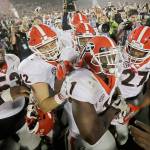 Georgias Sony Michel (1) celebrates with teammates after scoring the game-winning touchdown in the second overtime to give Georgia a 54-48 win over Oklahoma in the Rose Bowl on Monday in Pasadena, Calif. Georgia will play Alabama or Clemson for the national championship. (AP Photo/Doug Benc)