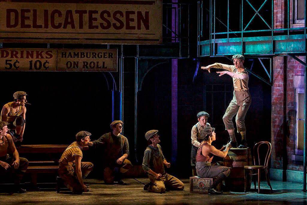 Everett native Lukas Poischbeg, standing on the barrel, plays Buttons, one of about a dozen of newsboys in Village Theatres Newsies. (Mark Kitaoka)