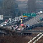 The eastbound lanes of U.S. 2 on the trestle near Everett were blocked when a dump truck pulling a trailer rolled over on Thursday. (Ian Terry / The Herald)