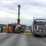 A tow truck crew works at the scene of a non-injury rollover dump truck with trailer. (Washington State Patrol)