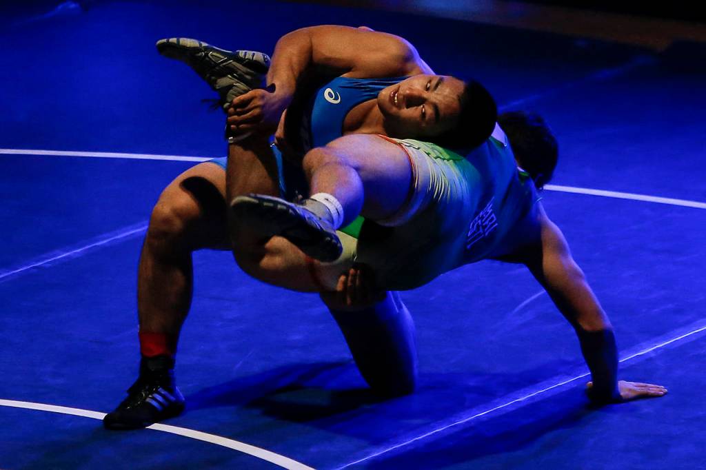 Japans Takumi Tanizaki (top) wrestles Everetts Christian Balmer during an exhibition match at Everett High School on Friday, Jan. 5. (Ian Terry / The Herald)