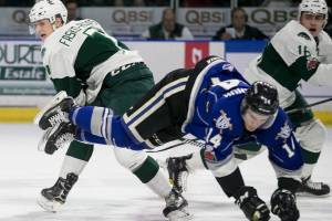 Victorias Eric Florchuk take to the air with Everetts Martin Fasko-Rudas, left, and Everetts Luke Ormsby at Angels of The Winds Arena Sunday night on January 7, 2018. championship. Silvertips won 9-4. (Kevin Clark / The Daily Herald)