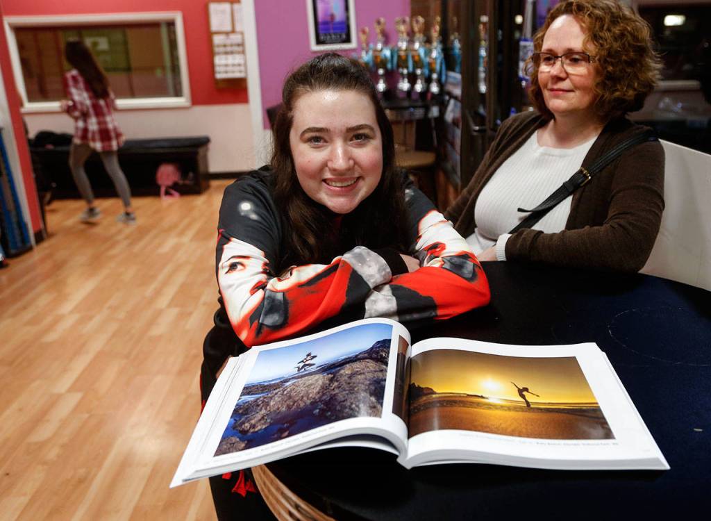 At Northwest Dance & Acro, Marysville Pilchuck High School sophomore Madison Young and her mother, Shanna Young, show off the teens photo (left) in the book Dance Across the USA. (Dan Bates / The Herald)