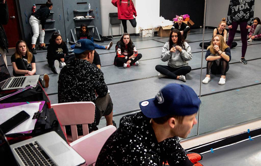 Surrounded by other teen girls, dance student Madison Young sits on the floor (center, red shoelaces) listening intently to instructor Andrew Faulkner, who is teaching hip hop Thursday night at Northwest Dance & Acro in Arlington. Faulkner, 33, took to dance at a very young age and has been teaching ever since. (Dan Bates / The Herald)