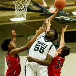 Shorecrests Philip Pepple (center) tips a shot back towards the hoop above Marysville Pilchucks RaeQuan Battle (left) and Corbin Sims (right) during a game on Jan. 9, 2018, at Shorecrest High School in Shoreline. (Ian Terry / The Herald)