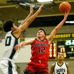 Marysville Pilchucks Josiah Gould (center) takes a shot as Shorecrests Latrell Jones (left) defends during a game Jan. 9, 2018, at Shorecrest High School in Shoreline. (Ian Terry / The Herald)