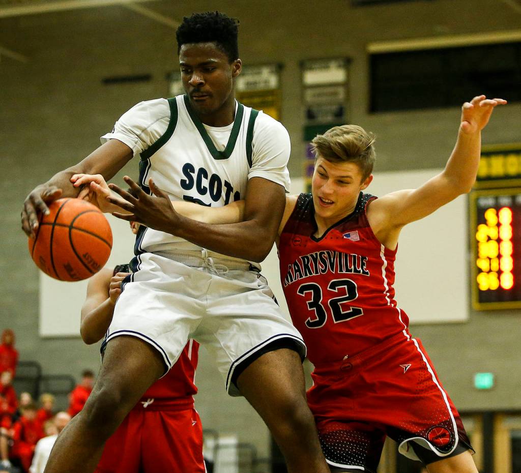 Shorecrests Philip Pepple (left) snatches a rebound away from Marysville Pilchucks Aaron Kalab (right) during a game Jan. 9, 2018, at Shorecrest High School in Shoreline. (Ian Terry / The Herald)
