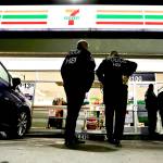 U.S. Immigration and Customs Enforcement agents serve an employment audit notice at a 7-Eleven convenience store Wednesday in Los Angeles. (AP Photo/Chris Carlson)